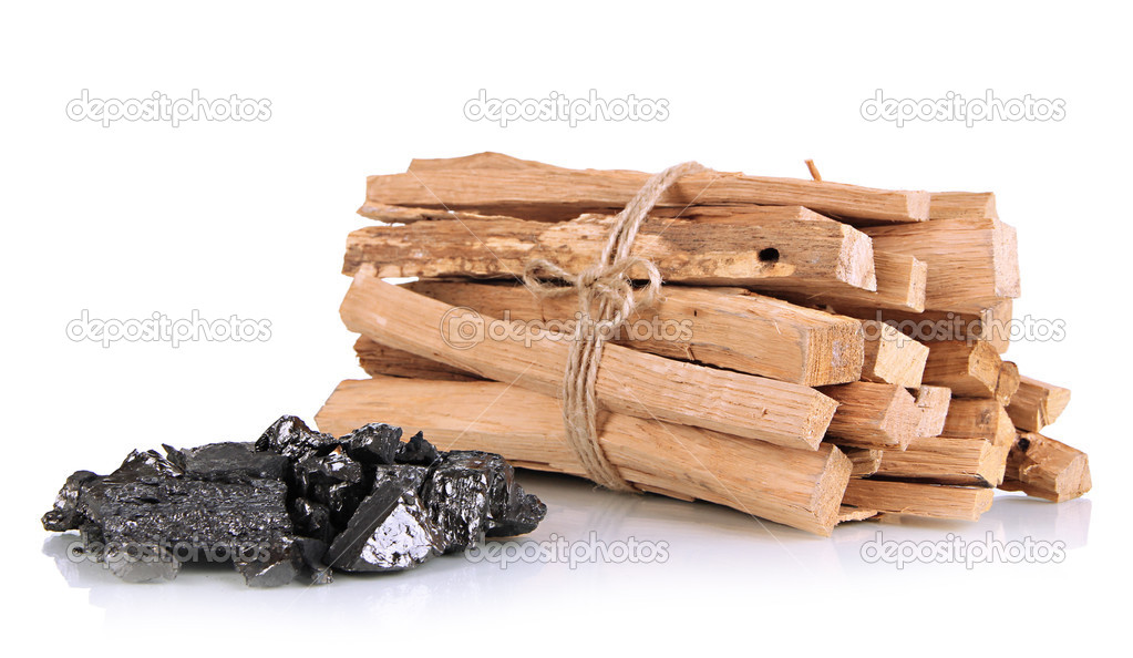 Stack of firewood and heap of coal isolated on white