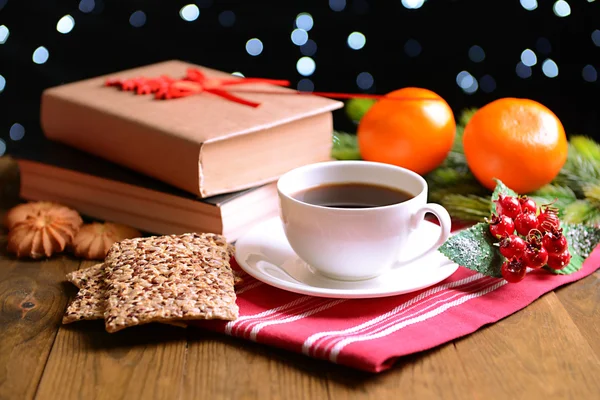 Composition of book with cup of coffee and Christmas decorations on table on dark background — Stock Photo, Image