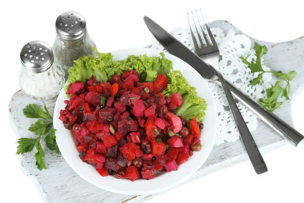 Beet salad on plate on napkin on wooden board isolated on white — Stock Photo, Image