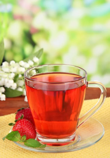 Delicious strawberry tea on table on bright background — Stock Photo, Image