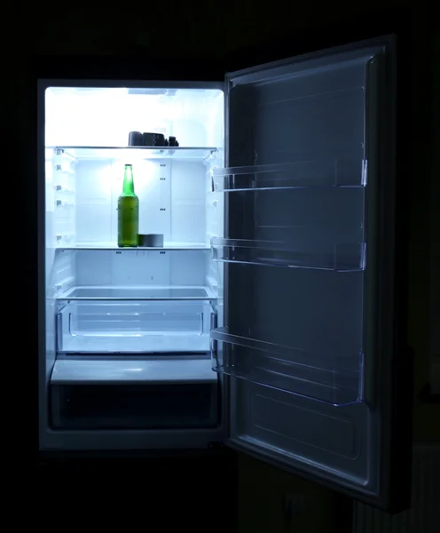 喝一杯啤酒瓶子和罐头的曲调里打开空空如也的冰箱： 学士冰箱概念. — 图库照片