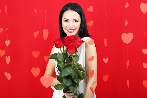 Attractive young woman with roses on Valentine Day — Stock Photo, Image