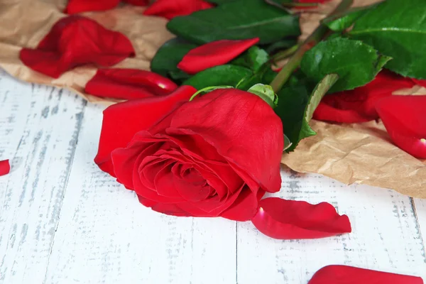 Rosa vermelha bonita na mesa de madeira close-up — Fotografia de Stock