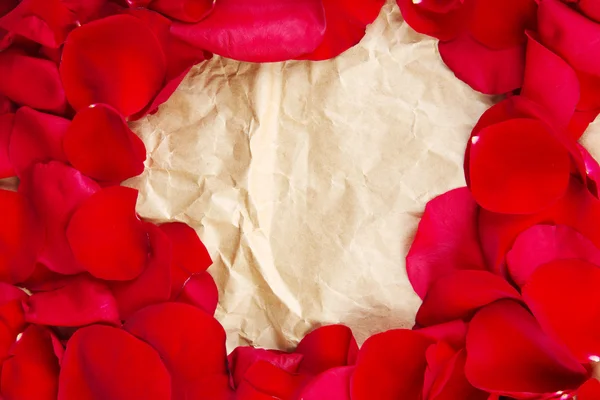 Frame of rose petals on vintage paper background close-up — Stock Photo, Image