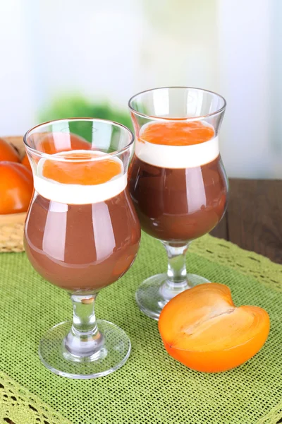 Dessert of chocolate and persimmon on table on light background — Stock Photo, Image