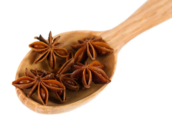 Star anise in wooden spoon, isolated on white — Stock Photo, Image