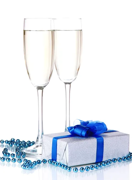 Glasses of champagne with gift box isolated on white — Stock Photo, Image