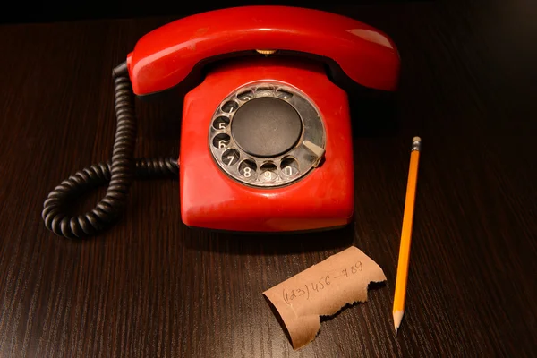 Red retro telephone,on dark wooden background — Stock Photo, Image