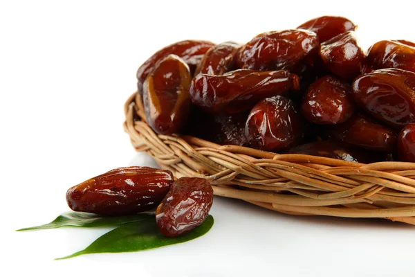 Dried dates on wicker plate isolated on white — Stock Photo, Image