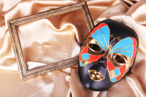 Mask on golden fabric background — Stock Photo, Image