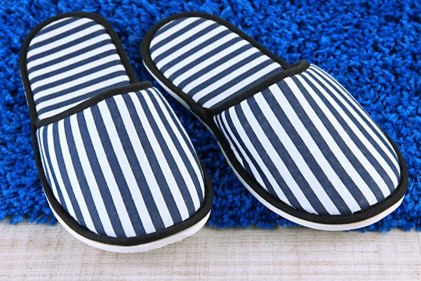 Striped slippers on floor background — Stock Photo, Image