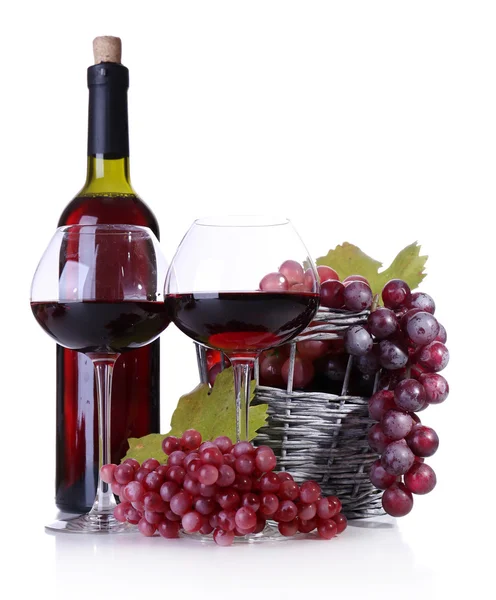 Wineglasses with red wine, grape and bottle isolated on white Royalty Free Stock Photos