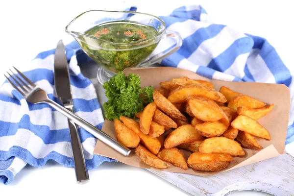 Home potatoes on tracing paper on wooden board near napkin isolated on white — Stock Photo, Image