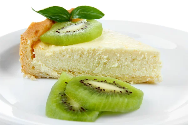 Slice of cheesecake with kiwi fruit on plate, isolated on white — Stock Photo, Image