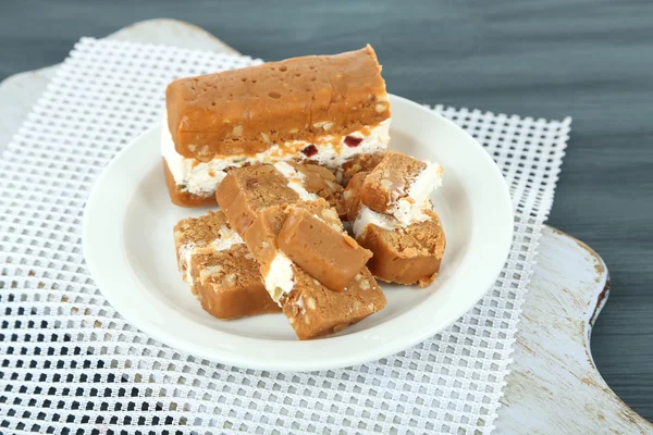 Sherbet with nuts on plate on wooden table close-up — Stock Photo, Image