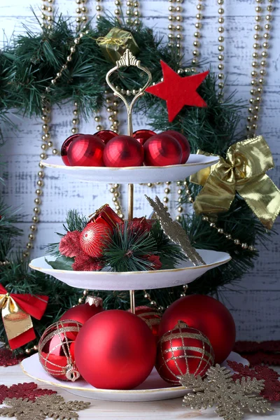 Christmas decorations on dessert stand, on color wooden background — Stock Photo, Image