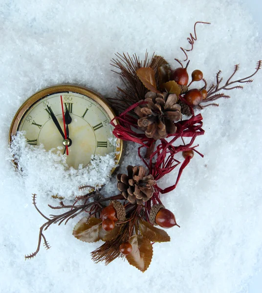 Clock and Christmas decorations under snow close up — Stock Photo, Image