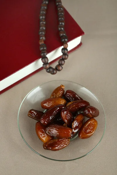 Composition with holy book,rosary and dates palm, on gray background — Stock Photo, Image