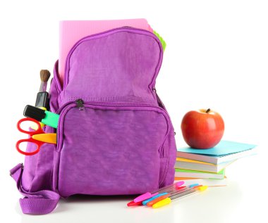 Okul malzemelerinin bulunduğu mor sırt çantası beyazın üzerinde.
