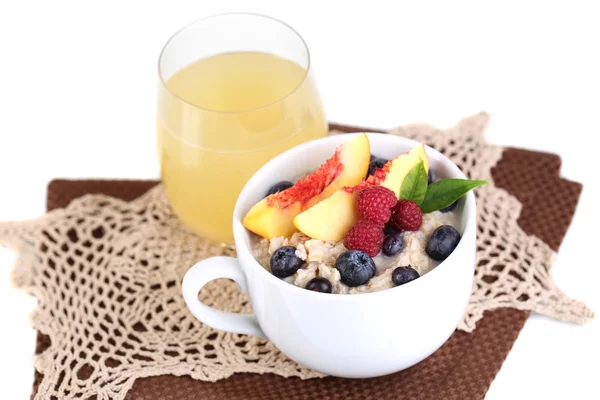 Oatmeal in cup with berries on napkins isolated on white — Stock Photo, Image