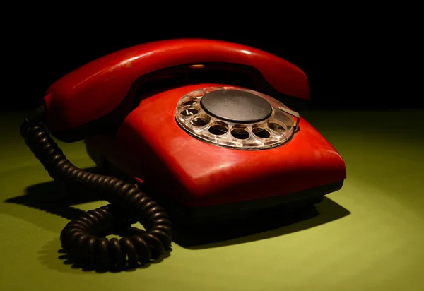 Red retro telephone on dark color background — Stock Photo, Image