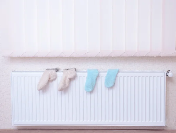 Socks drying on heating radiator — Stock Photo, Image
