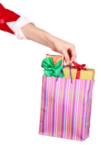 Hand holds package with New Year gifts isolated on white — Stock Photo, Image