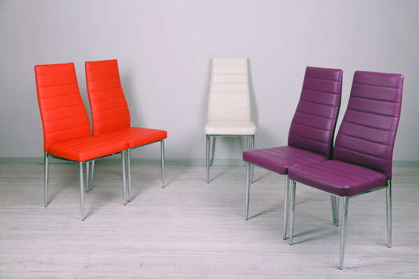 Modern color chairs on wall background