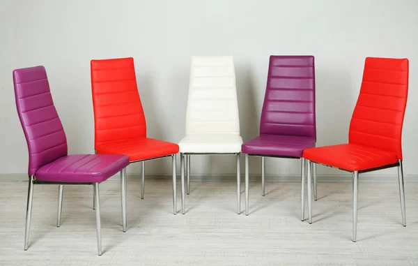 Modern color chairs on wall background — Stock Photo, Image