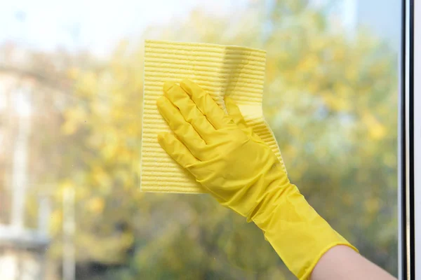 Hands with napkin cleaning window — Stock Photo, Image