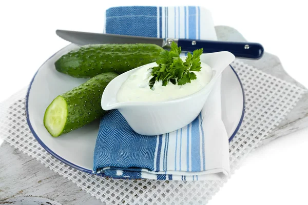 Cucumber yogurt in sauceboat, on color napkin, isolated on white — Stock Photo, Image