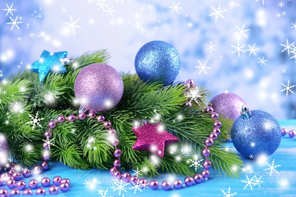 Christmas balls on fir tree, on color background — Stock Photo, Image