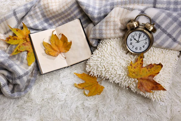 Composition with warm plaid, book, on color carpet background — Stock Photo, Image