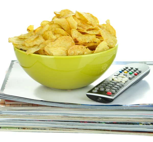 Chips in bowl and TV remote isolated on white — Stock Photo, Image