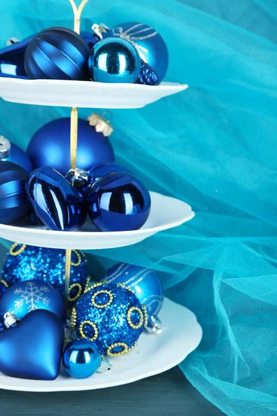 Christmas decorations on dessert stand, on color background — Stock Photo, Image