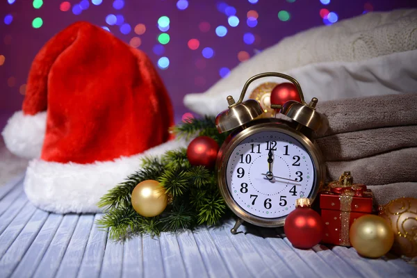 Composition with retro alarm clock and Christmas decoration on bright background — Stock Photo, Image