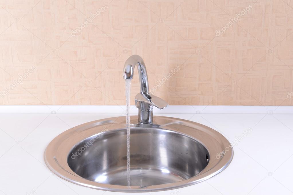 Water tap and sink in modern kitchen