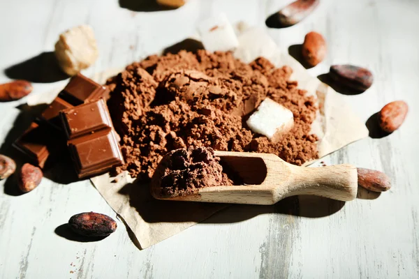 Cocoa powder on wooden table — Stock Photo, Image