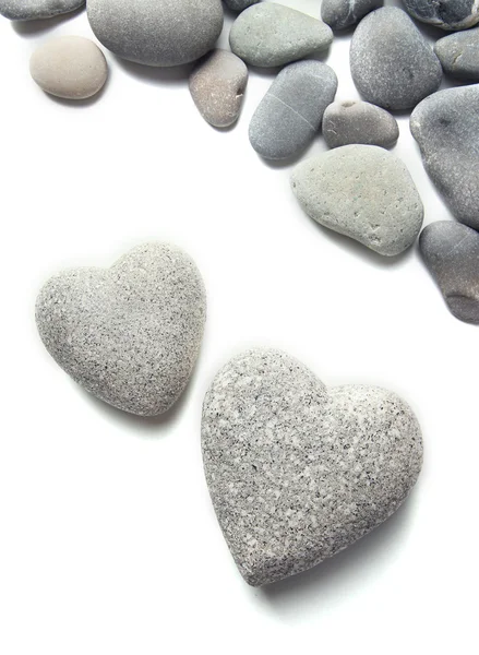 Piedras grises en forma de corazón, aisladas en blanco —  Fotos de Stock