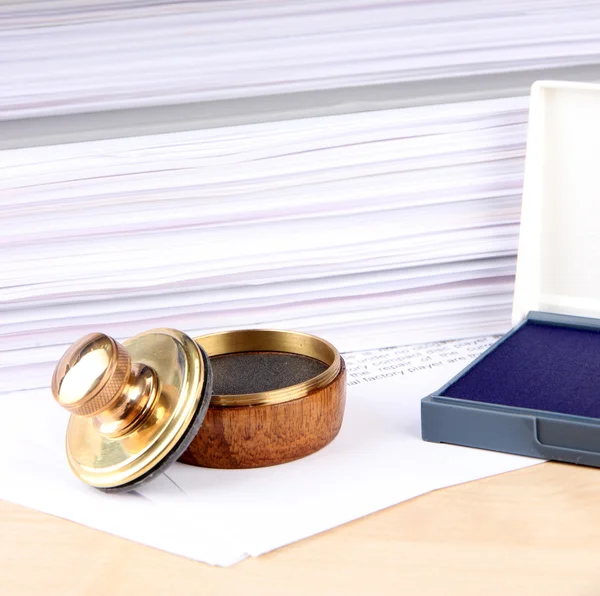 Wooden stamp and papers on table — Stock Photo, Image
