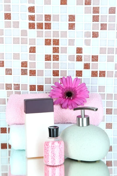 Cosmetics and bath accessories on mosaic tiles background — Stock Photo, Image