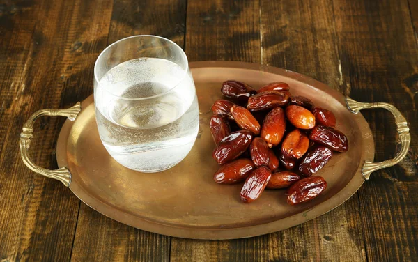 Conceptual photo of Ramadan food:dates and water — Stock Photo, Image