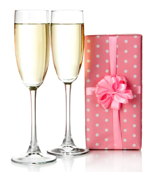 Glasses of champagne with gift box isolated on white — Stock Photo, Image