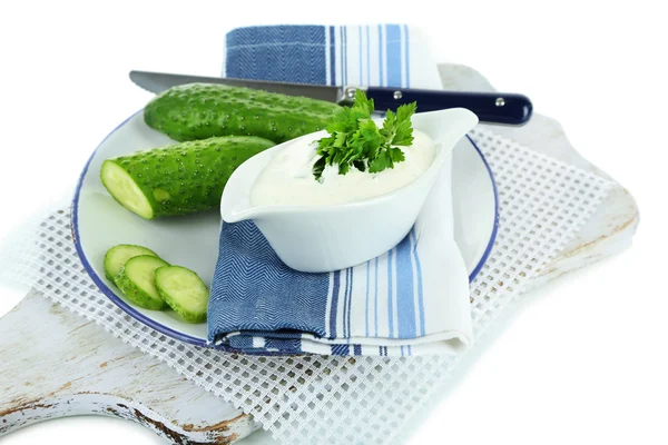 Cucumber yogurt in sauceboat, on color napkin, isolated on white — Stock Photo, Image