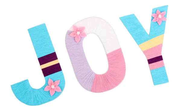 Word Joy créé avec cour à tricoter aux couleurs vives isolé sur blanc — Photo