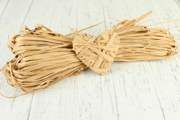 Paja decorativa para la mano y corazón de paja, sobre fondo de madera — Foto de Stock