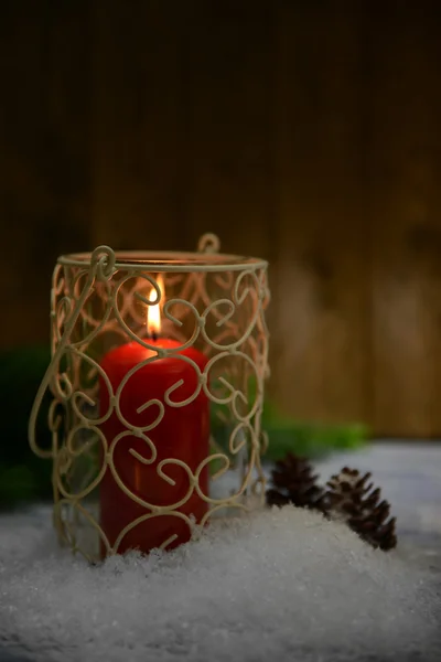 Candle and Christmas tree bud on wooden background — Stock Photo, Image