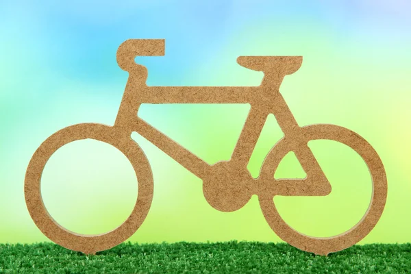 Decorative bicycle on grass on bright background — Stock Photo, Image