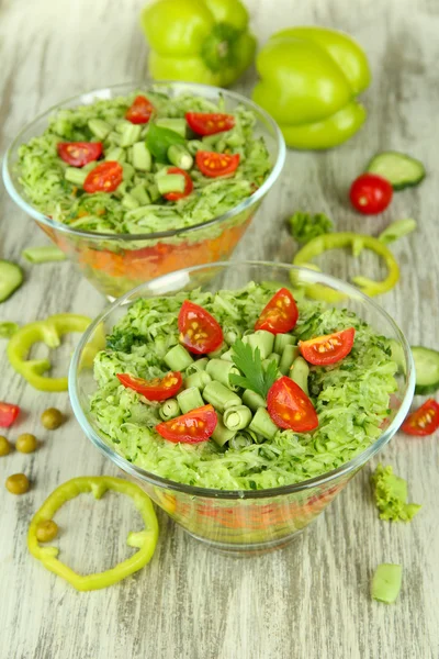 Tasty salad with fresh vegetables on wooden table — Stock Photo, Image