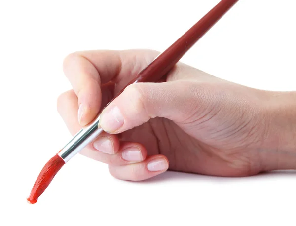 与白色上隔离的红漆拿画笔的手 — 图库照片